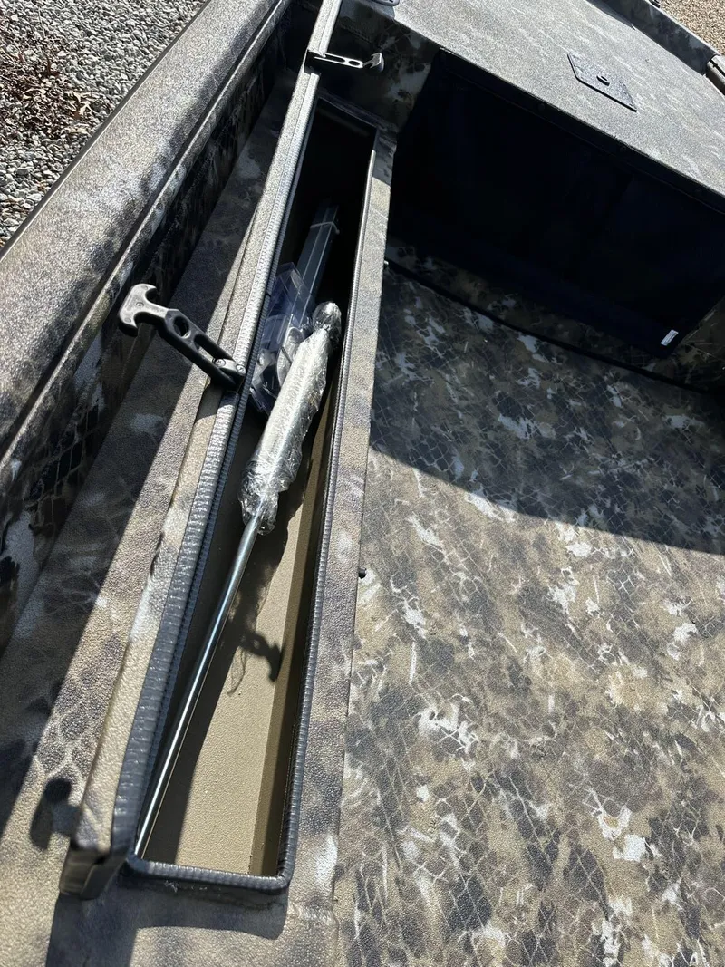 Slide: The Image of 2025 Excel Viper F4 1751 boat interior with storage compartment and camo design. - 10