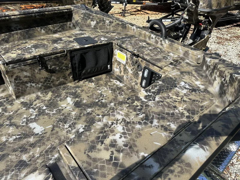 Slide: The Image of Camouflage-patterned deck of 2025 Excel Viper F4 1751 boat, featuring storage compartments and controls. - 8