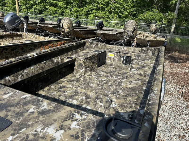 Slide: The Image of 2025 Excel Viper F4 1751 boat with camouflage design, parked outdoors. - 11