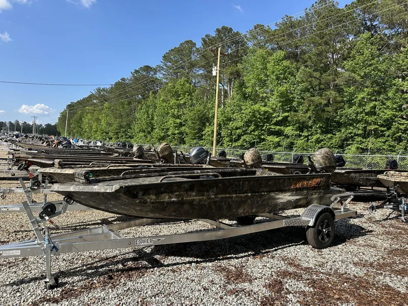 Slide: The Image of Row of 2025 Excel Viper F4 1751 boats on trailers in a wooded area. - 14