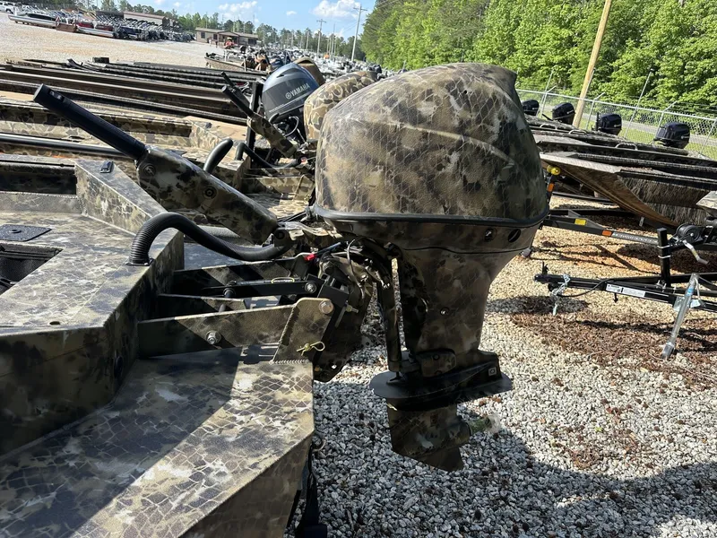 Slide: The Image of Camouflage-patterned Excel Viper F4 1751 boat motor, 2025 model, on gravel lot. - 4