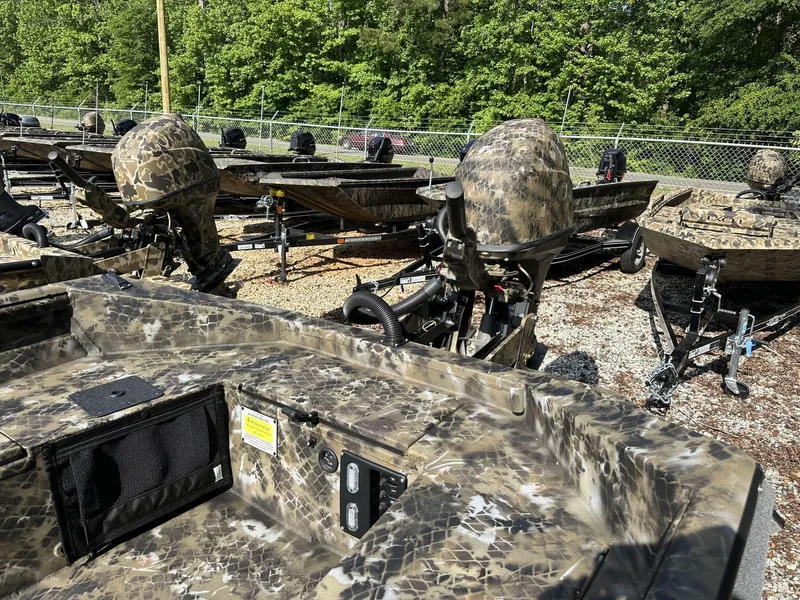 Slide: The Image of Camouflage-patterned Excel Viper F4 1751 boats, 2025 model, parked outdoors on gravel. - 7