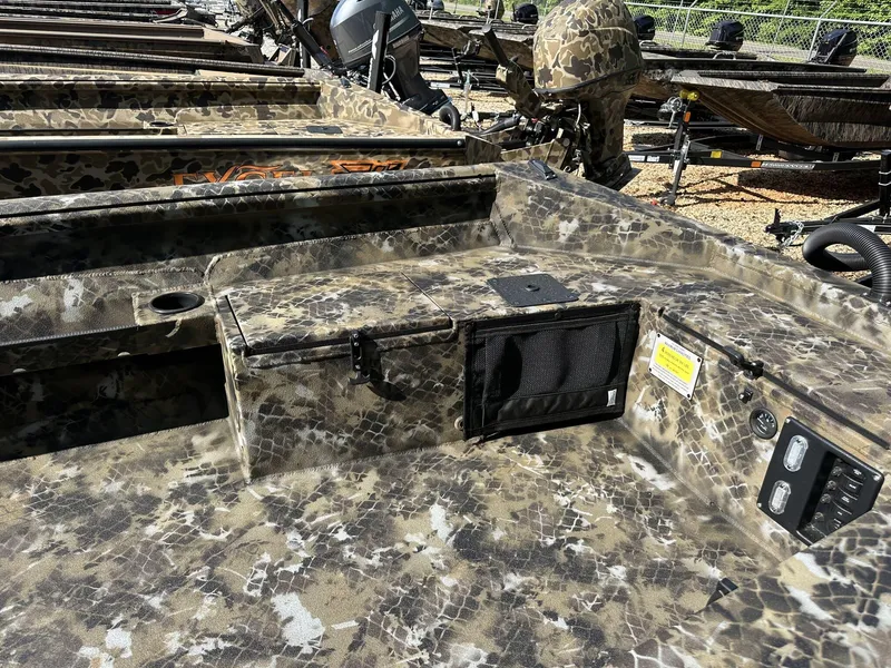 Slide: The Image of Camouflage-patterned Excel Viper F4 1751 boat interior, 2025 model, with storage compartments and controls. - 9