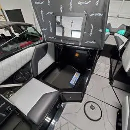 Slide: The Image of 2022 Tigé Z3 boat interior with open storage compartment and stylish seating. - 2
