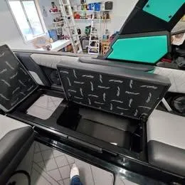 Slide: The Image of 2022 Tigé Z3 boat interior with open storage compartments in a garage setting. - 3