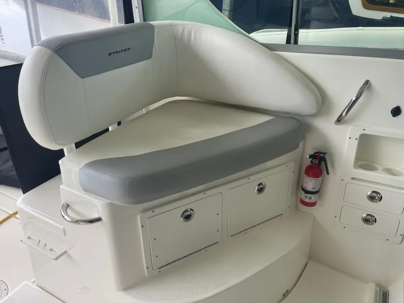 Slide: The Image of 2015 Seaswirl Striper Alaskan Edition boat interior with cushioned seating and storage compartments. - 11