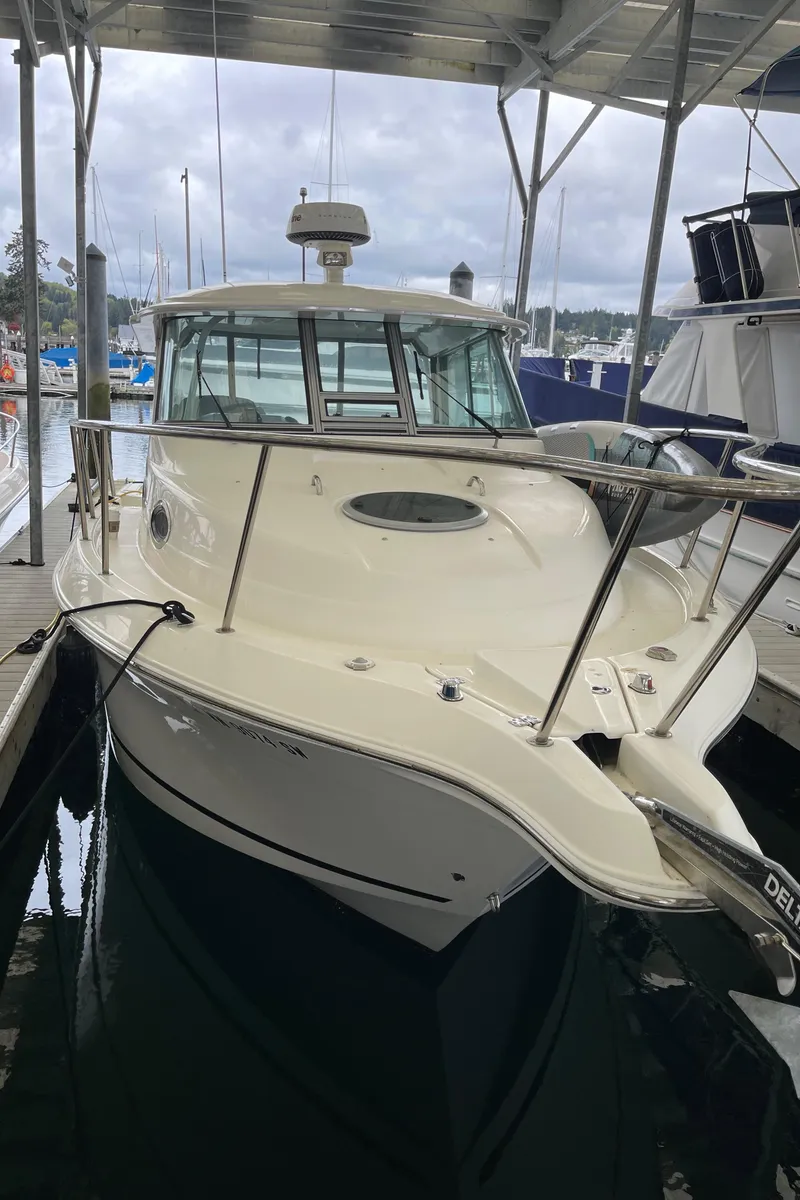 Slide: The Image of 2015 Seaswirl Striper Alaskan Edition boat docked in a marina under a covered area. - 15
