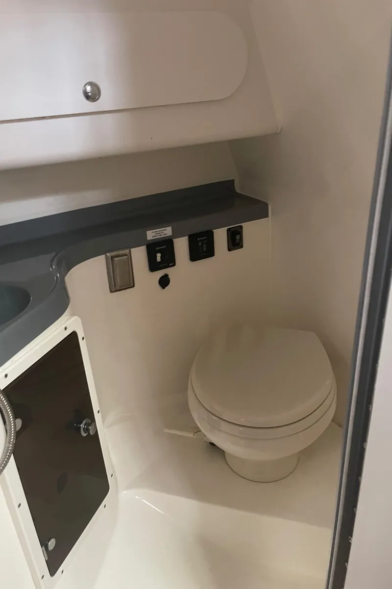 Slide: The Image of 2015 Seaswirl Striper Alaskan Edition boat interior bathroom with toilet and storage. - 18