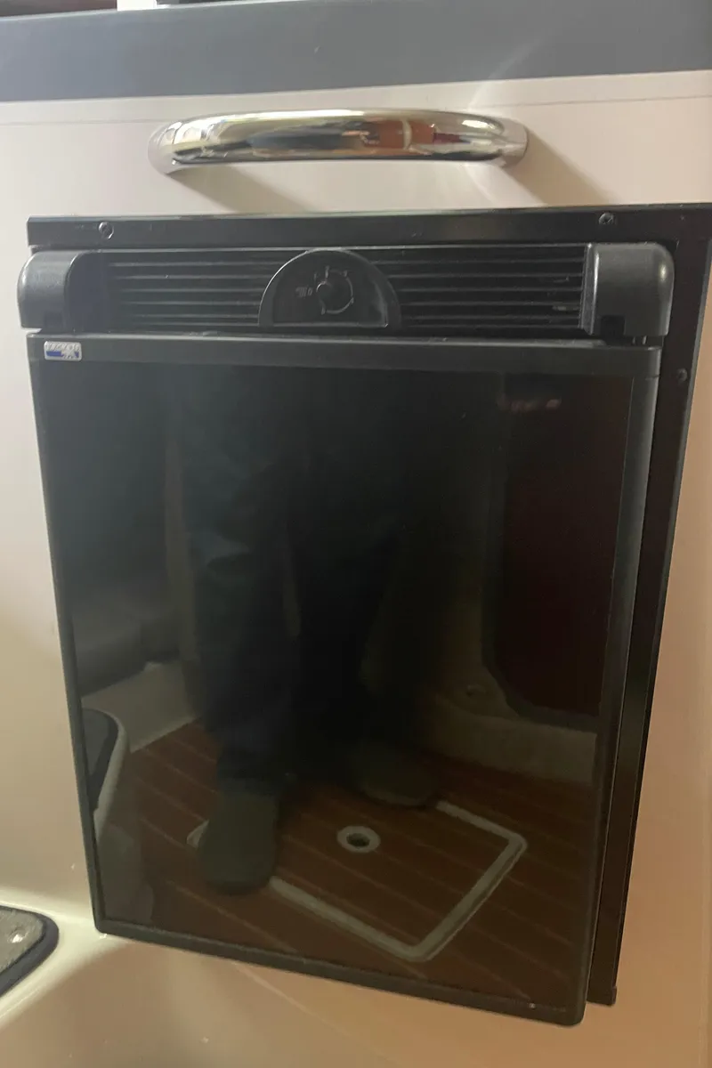 Slide: The Image of 2015 Seaswirl Striper Alaskan Edition boat interior with a compact black refrigerator. - 20