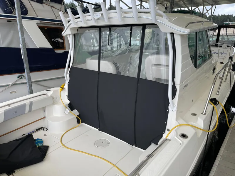 Slide: The Image of 2015 Seaswirl Striper Alaskan Edition boat docked, featuring a covered cockpit area. - 23