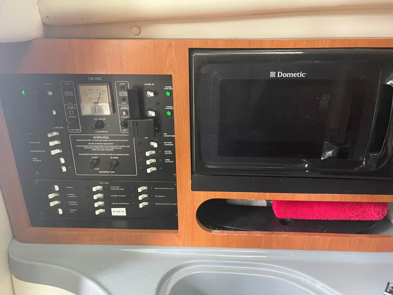 Slide: The Image of Control panel and microwave in 2015 Seaswirl Striper Alaskan Edition boat interior. - 3
