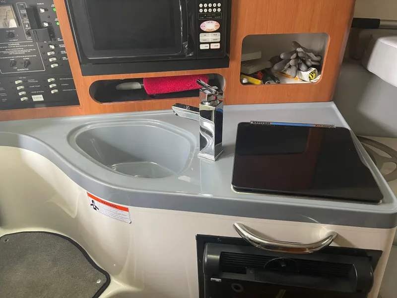 Slide: The Image of 2015 Seaswirl Striper Alaskan Edition boat interior with sink, faucet, and control panel. - 4