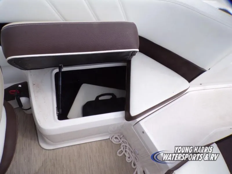 Slide: The Image of Open storage compartment in 2017 Regal 2000 ES boat interior with brown and white seating. - 12