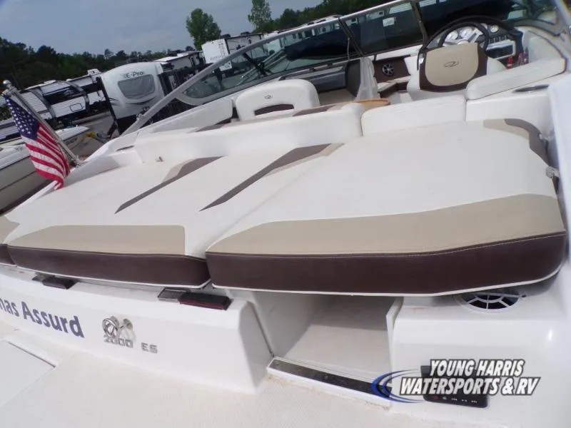 Slide: The Image of 2017 Regal 2000 ES boat with cushioned seating and American flag, displayed at Young Harris Watersports. - 5