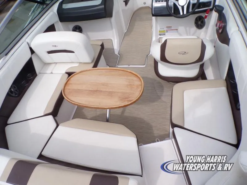 Slide: The Image of Interior of a 2017 Regal 2000 ES boat with seating and a wooden table. - 7