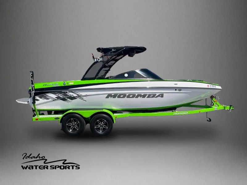 Slide: The Image of 2014 Moomba Mobius LSV boat with vibrant green accents on a trailer. - 1