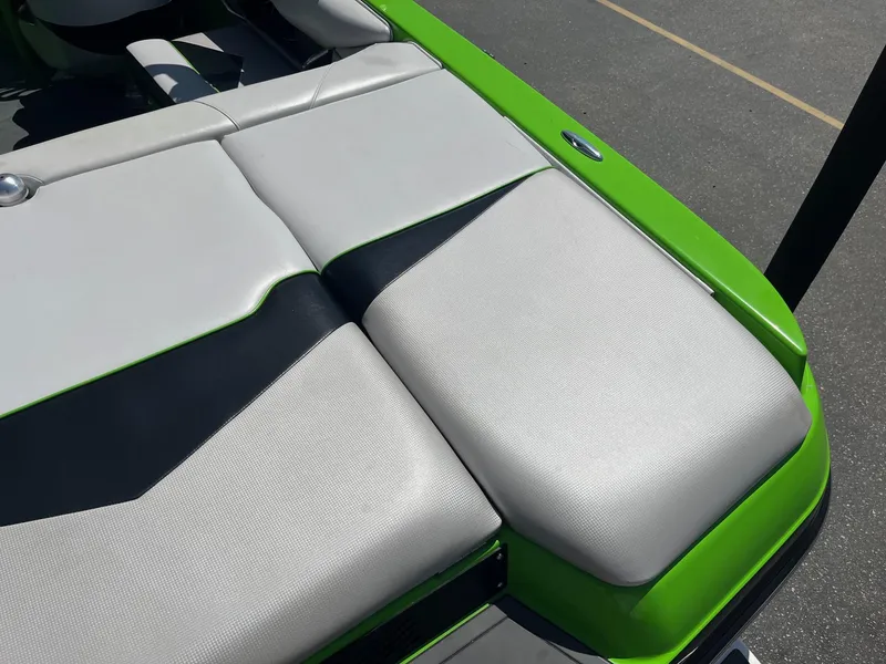 Slide: The Image of 2014 Moomba Mobius LSV boat with green and gray seating detail. - 18