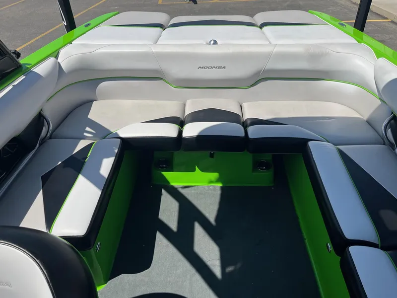 Slide: The Image of 2014 Moomba Mobius LSV interior with green and gray seating, showcasing spacious design. - 19