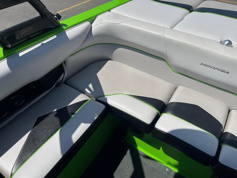 Slide: The Image of 2014 Moomba Mobius LSV interior with green and white seating, showcasing modern design. - 21