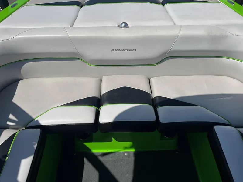 Slide: The Image of 2014 Moomba Mobius LSV boat interior with white and green seating. - 22