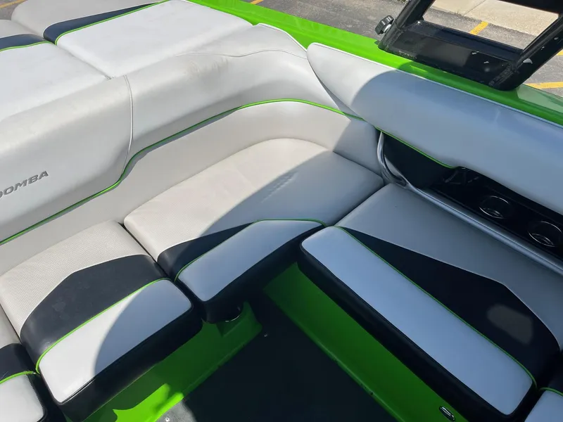 Slide: The Image of 2014 Moomba Mobius LSV interior with green and black accents, showcasing seating area. - 23