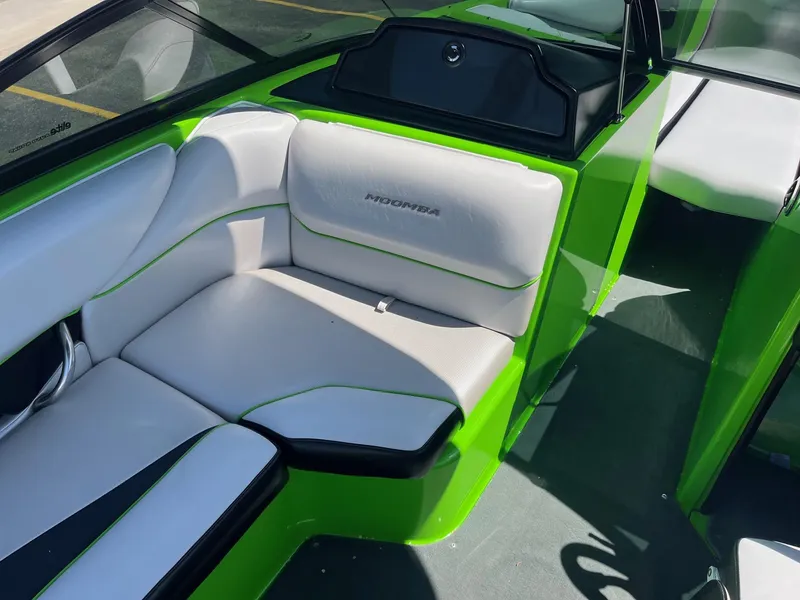 Slide: The Image of 2014 Moomba Mobius LSV boat interior with green and white seating. - 25