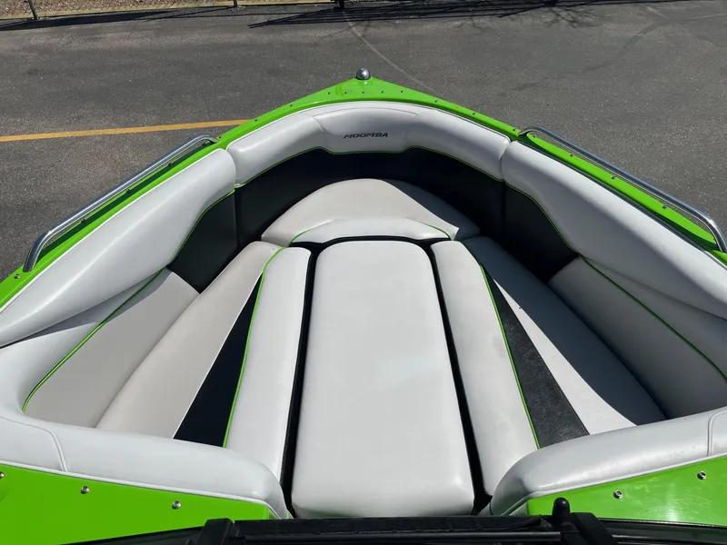 Slide: The Image of 2014 Moomba Mobius LSV boat interior with green and gray seating. - 29