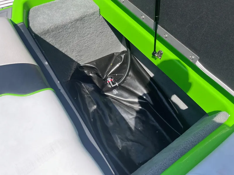 Slide: The Image of 2014 Moomba Mobius LSV boat storage compartment with green and gray interior. - 32