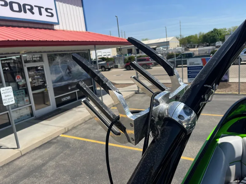 Slide: The Image of 2014 Moomba Mobius LSV boat with wakeboard rack outside a sports shop. - 35