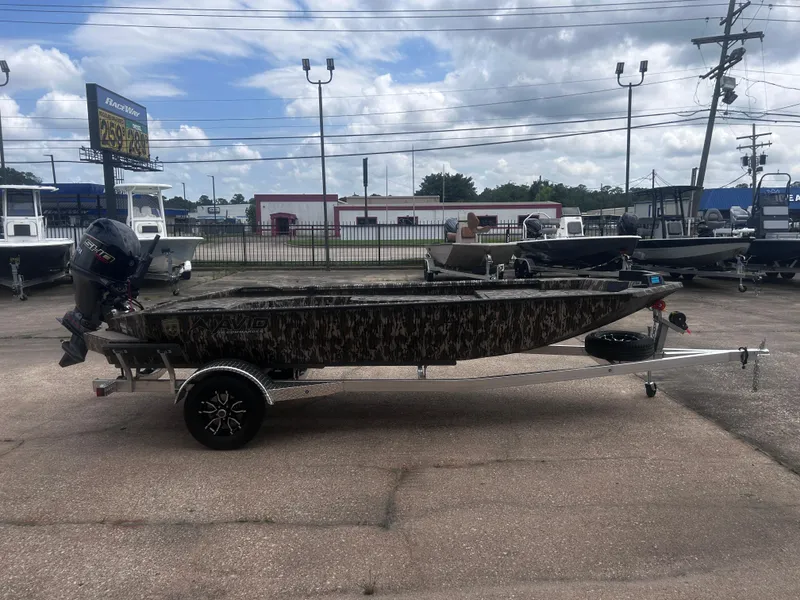 Slide: The Image of 2025 Avid 18 Commander boat on trailer, camo design, outdoor dealership setting. - 6