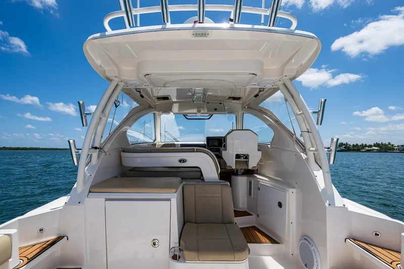 Slide: The Image of 2017 Pursuit 325 OS boat interior with seating, helm, and ocean view. - 19
