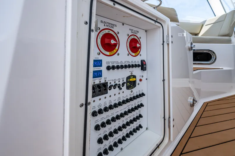 Slide: The Image of Electrical panel on a 2017 Pursuit 325 OS boat, featuring switches and controls. - 26