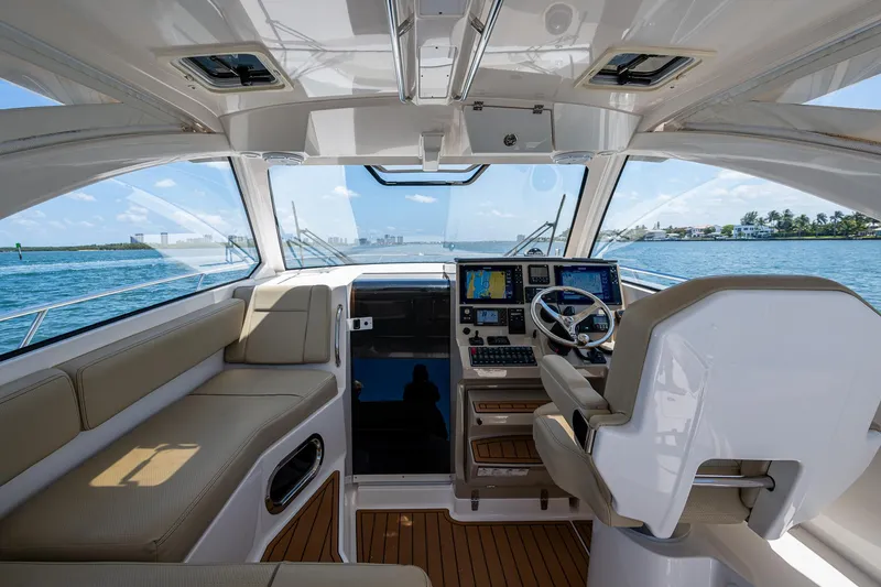 Slide: The Image of Interior of 2017 Pursuit 325 OS boat with modern helm and seating, overlooking ocean. - 31