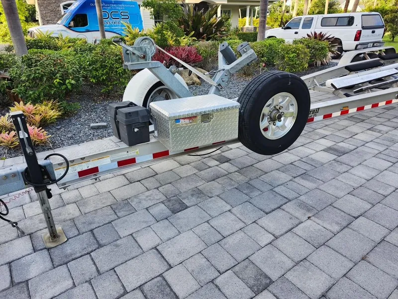 Slide: The Image of Trailer for 2017 Pursuit 325 OS boat on paved driveway. - 40