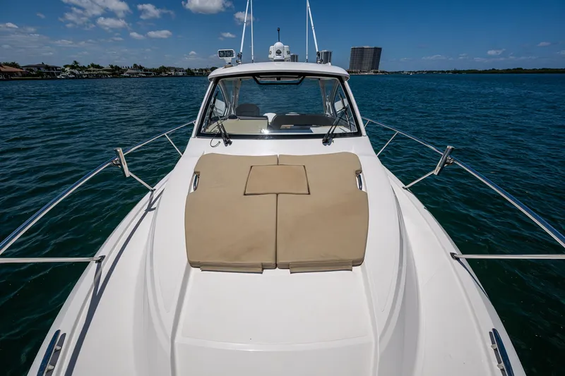 Slide: The Image of 2017 Pursuit 325 OS boat on water, featuring spacious deck and clear skies. - 6