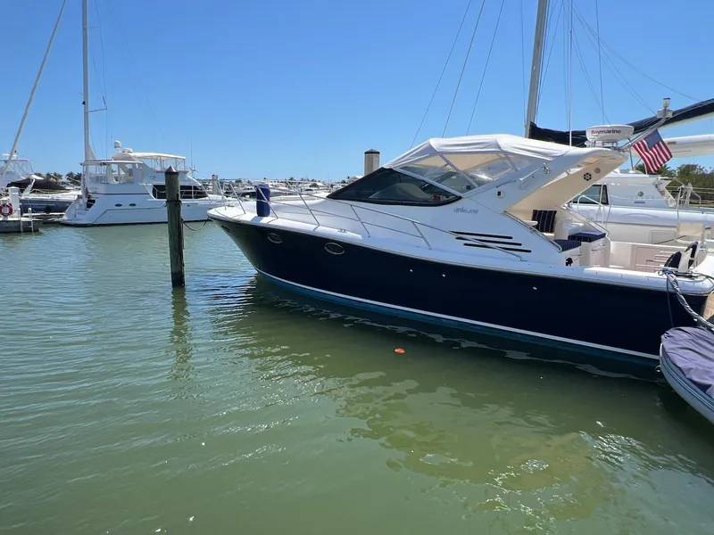 Slide: The Image of 2001 Uniesse 42 Open yacht docked in a marina under clear blue skies. - 1
