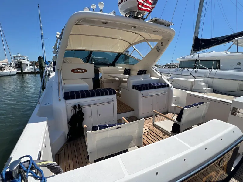Slide: The Image of 2001 Uniesse 42 Open yacht with spacious deck and seating at marina. - 11