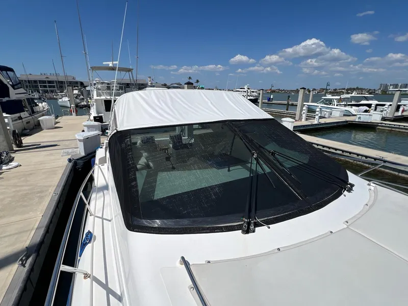 Slide: The Image of 2001 Uniesse 42 Open yacht docked at marina under clear blue sky. - 15