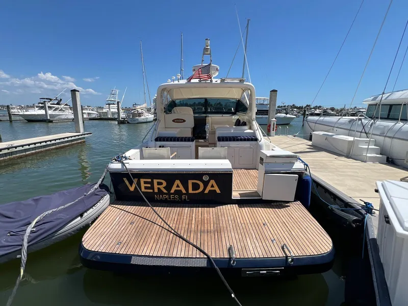 Slide: The Image of 2001 Uniesse 42 Open yacht docked, rear view, with "VERADA" nameplate, Naples, FL. - 2