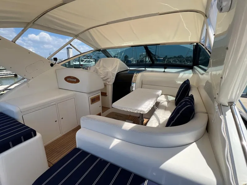 Slide: The Image of Luxurious 2001 Uniesse 42 Open yacht interior with elegant seating and table. - 21