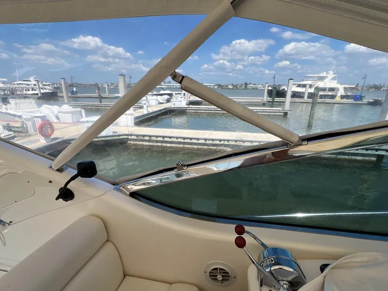 Slide: The Image of 2001 Uniesse 42 Open yacht interior with marina view, clear skies, and calm waters. - 24