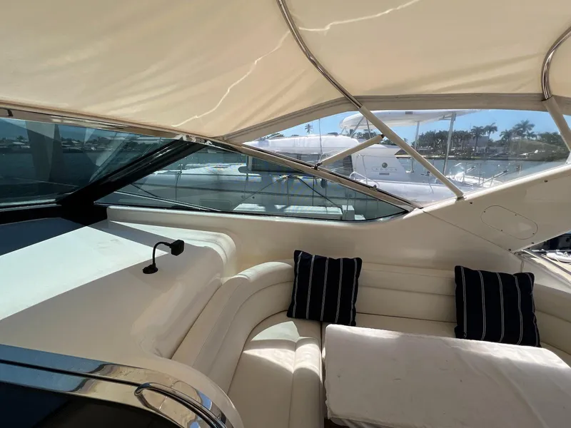 Slide: The Image of Interior view of 2001 Uniesse 42 Open yacht with cushioned seating and striped pillows. - 26
