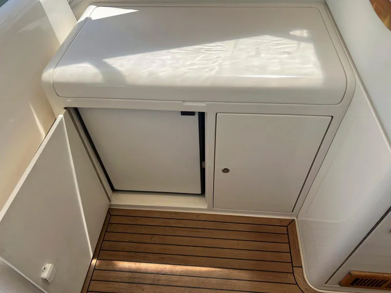 Slide: The Image of 2001 Uniesse 42 Open yacht interior with wooden flooring and white cabinetry. - 27