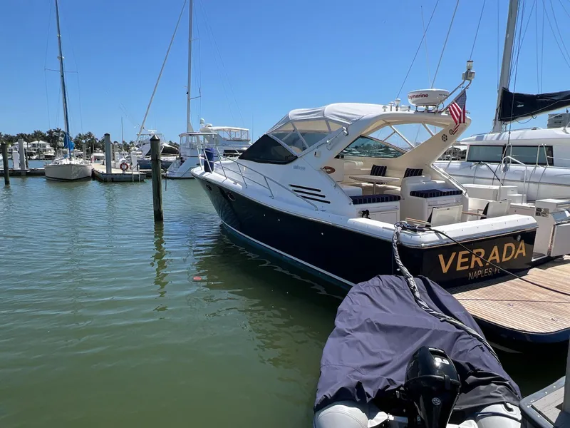Slide: The Image of 2001 Uniesse 42 Open yacht docked in a marina under clear blue skies. - 3