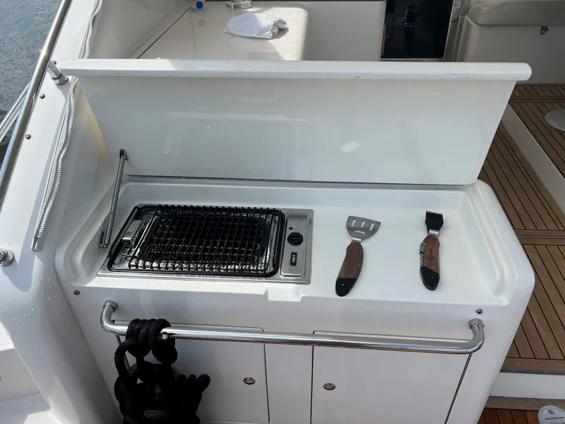 Slide: The Image of Outdoor grill station on 2001 Uniesse 42 Open yacht with utensils. - 31