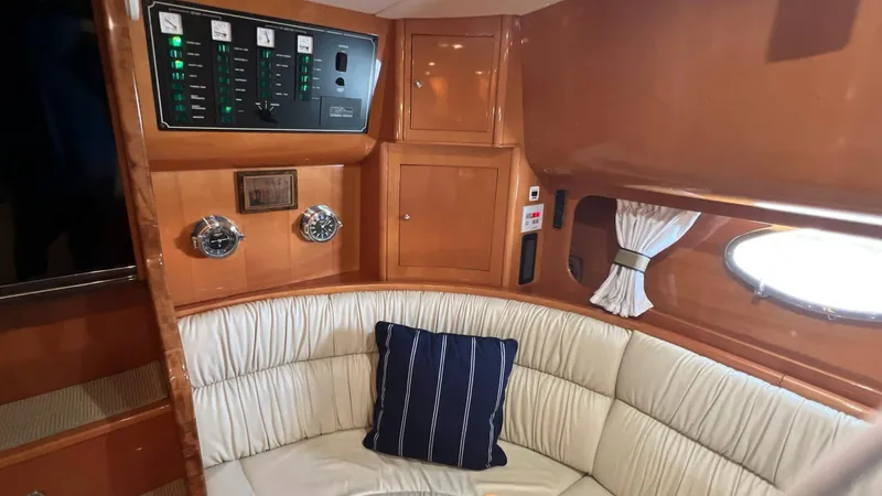 Slide: The Image of Interior of 2001 Uniesse 42 Open yacht with cushioned seating and control panel. - 36