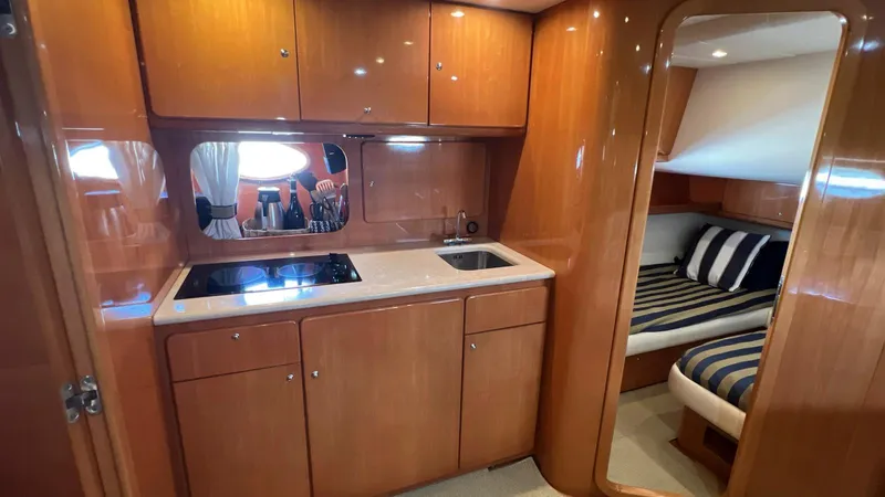 Slide: The Image of 2001 Uniesse 42 Open yacht interior with kitchen and cozy cabin. - 38