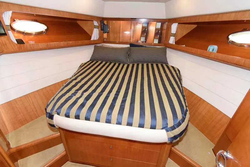 Slide: The Image of Luxurious cabin interior of 2001 Uniesse 42 Open yacht with striped bedding. - 39
