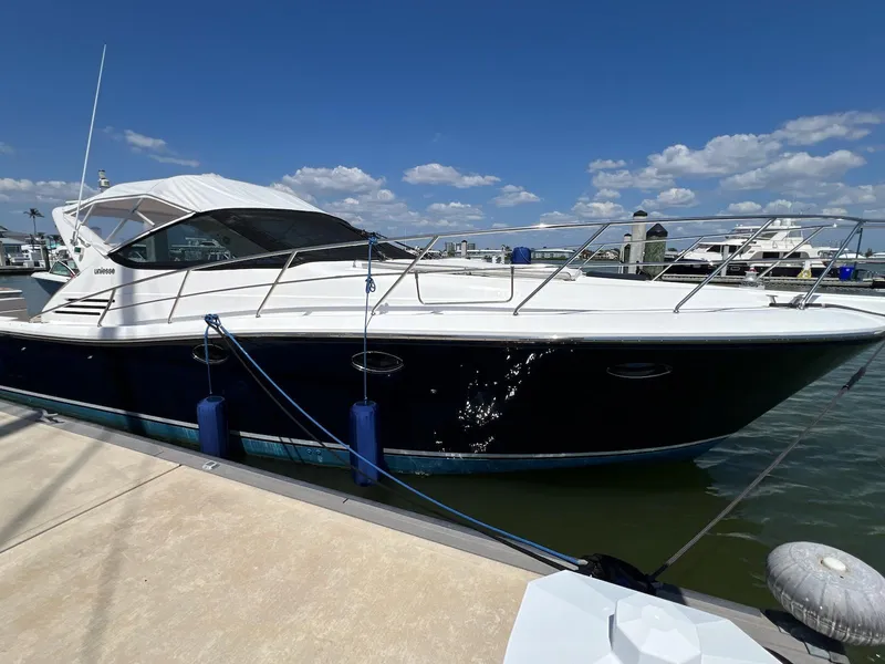 Slide: The Image of 2001 Uniesse 42 Open yacht docked at marina under clear blue sky. - 4