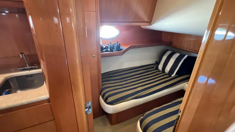 Slide: The Image of 2001 Uniesse 42 Open cabin with striped bedding and wooden interior. - 41